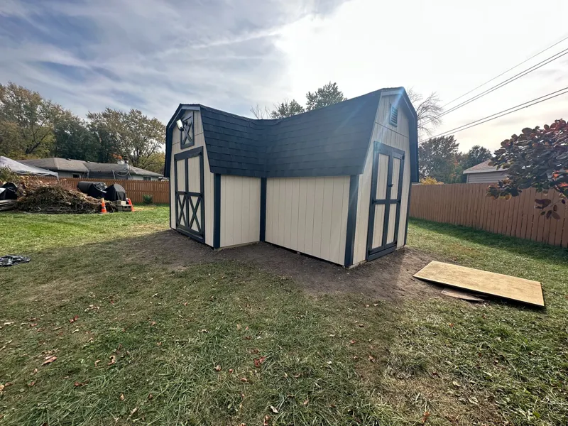 Backyard barn shed with a new shingle roof