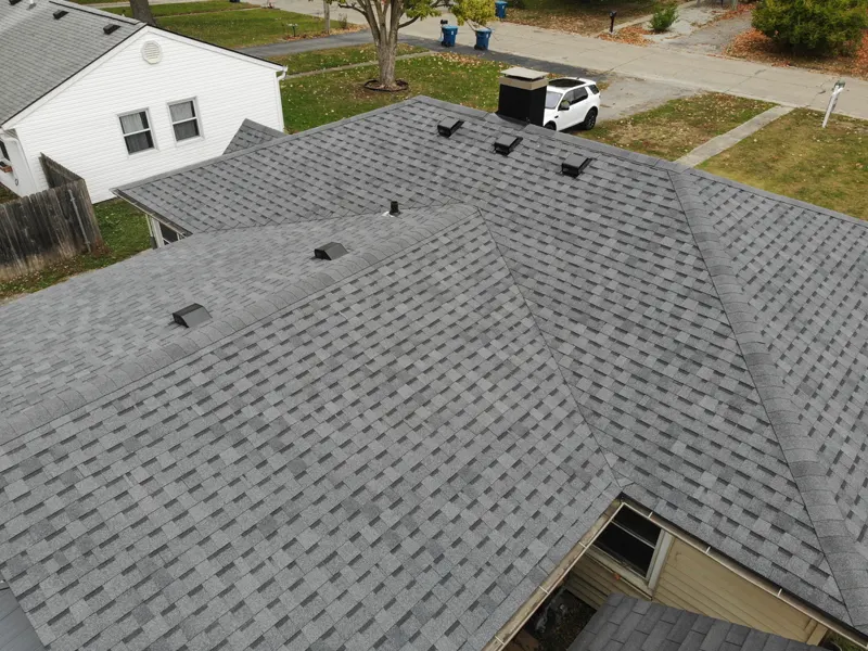 Drone view of a completed architectural shingle roof on a large two-story home in the Center Grove area