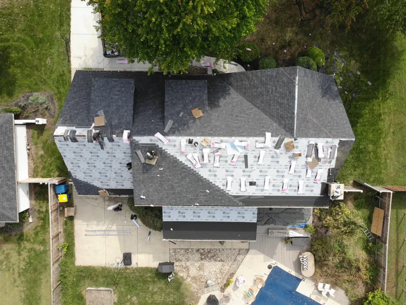 Drone photo of a large roof half covered in underlayment during installation