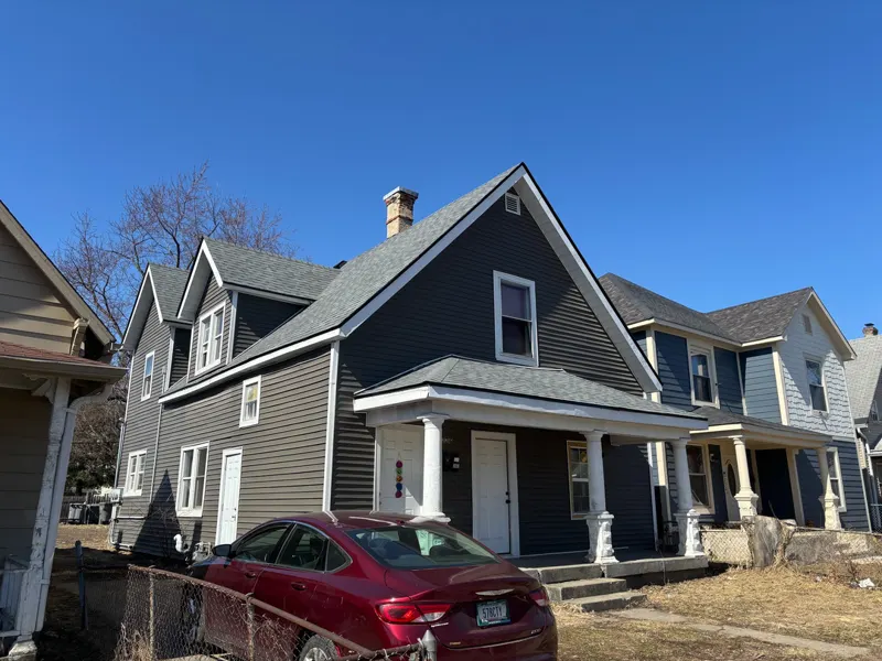 Older two-story home with a brand new architectural shingle roof