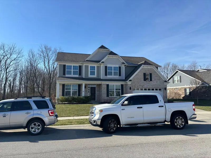 Finished roof replacement on a two-story home seen from the street